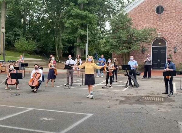 Elisabeth Morrow School Arts Department performing the Apple Tree Song outside on blacktop.