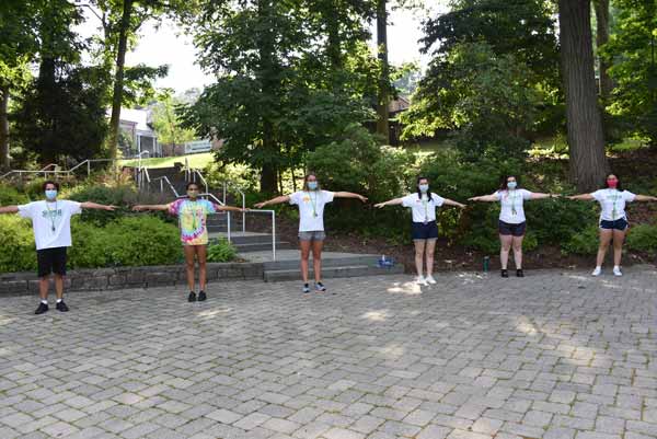 Summer Explorations camp counselors standing 6-feet apart