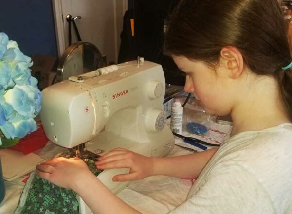 Elisabeth Morrow School student Aubrey D. sewing COVID-19 masks.