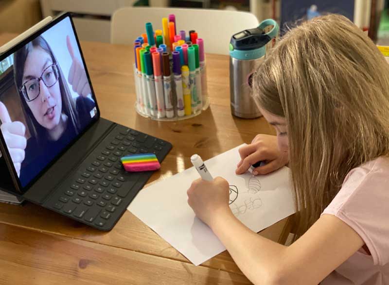 Elisabeth Morrow School student drawing in front of laptop.