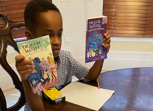 Young student holding up books