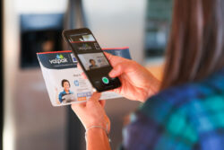 photo of a person taking a picture of their mail with their smartphone