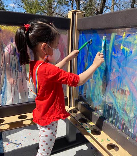 Chilton House Kindergarten Student Painting Outside at The Elisabeth Morrow School