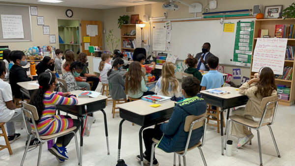 Seth Odei-Danso speaking with fourth-graders in their classroom.