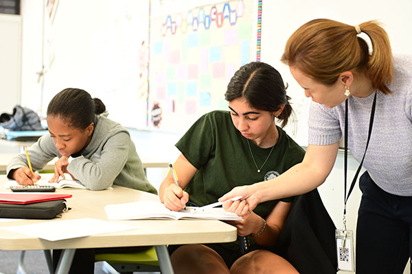 Teacher helping student with classroom problem