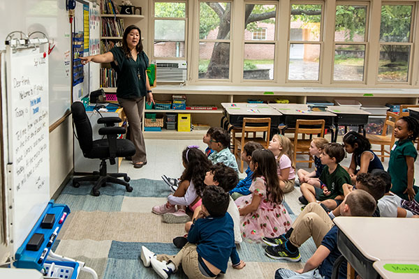 Little School students listen to their teacher during class.