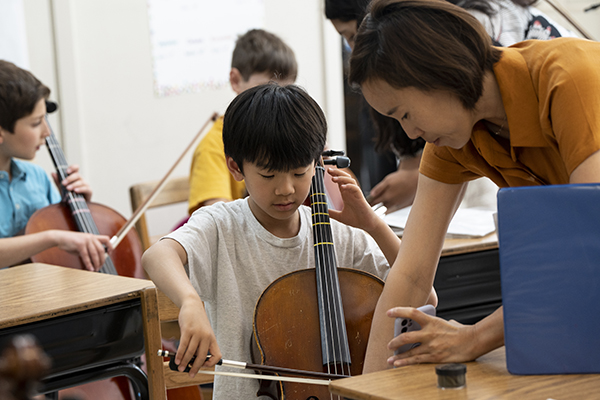 A Little School student practices the cello.