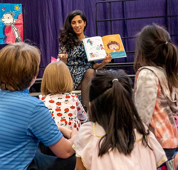 Author reading to students at the Book Fair