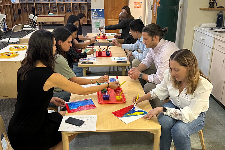 Parents doing a craft at Back-to-School Night.