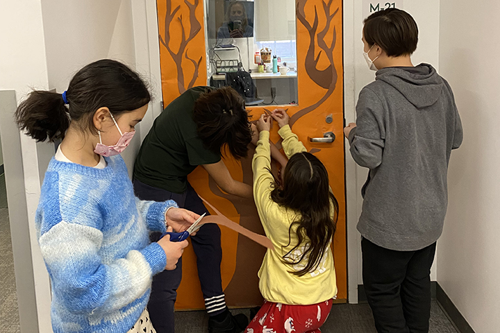 Students decorating a classroom door during Advisory.