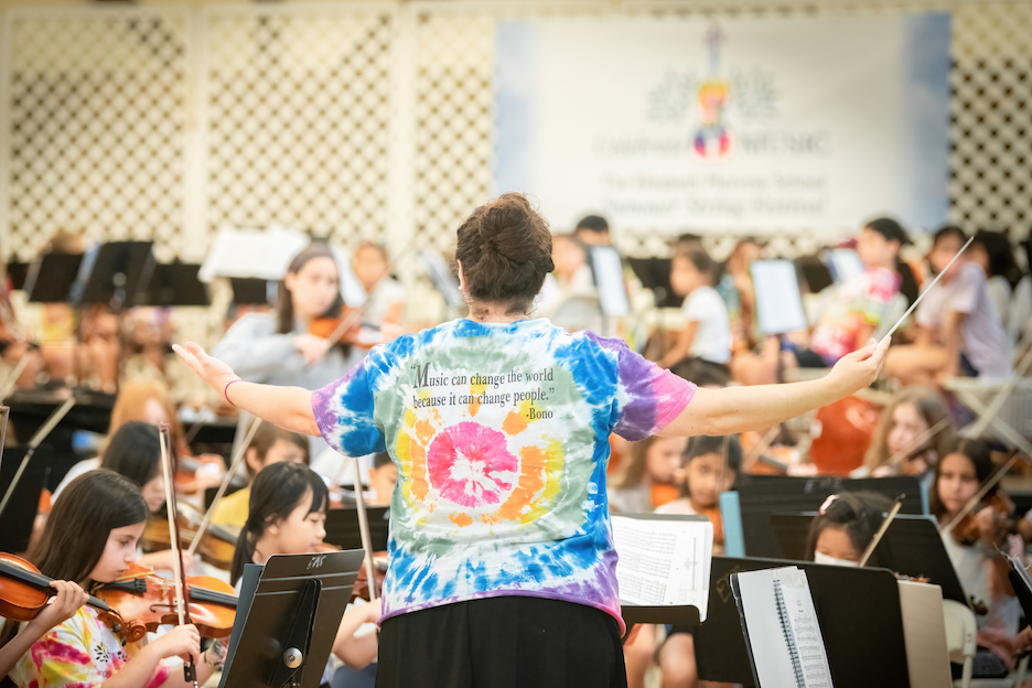 Faculty conducting the orchestra