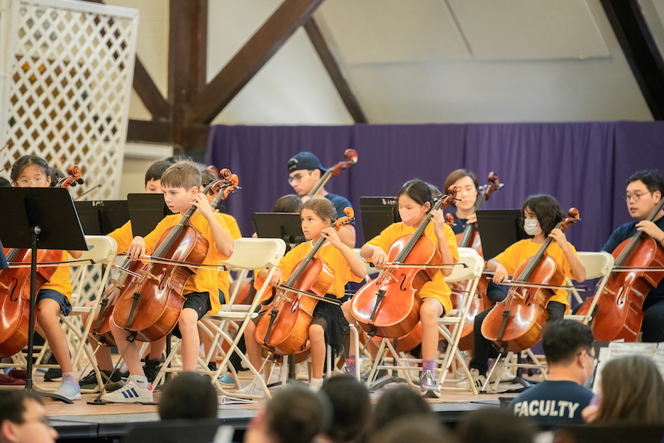 Students practicing with their cellos.