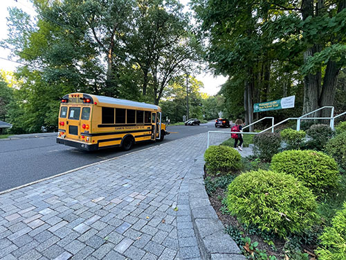 bus transportation to EMS with student walking up the steps after exiting