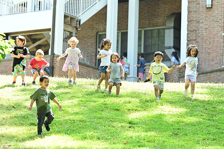 Young kids running down the Morrow House hill.