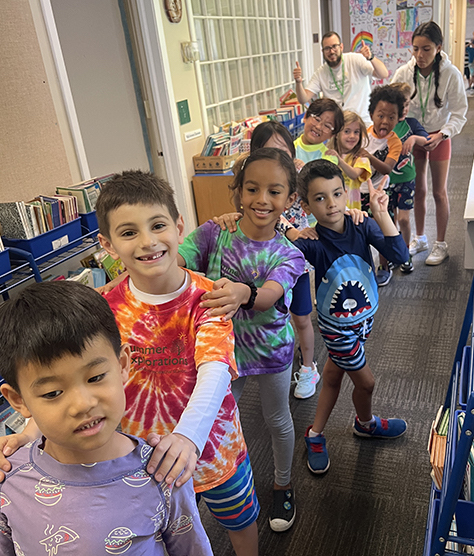 Campers walking down the hall smiling