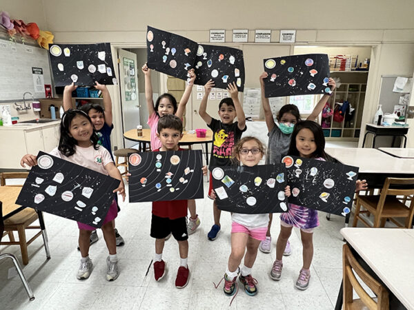 Summer Explorations campers holding up their solar system projects