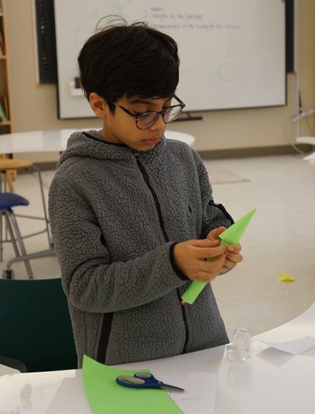 A student working on building their model rocket.