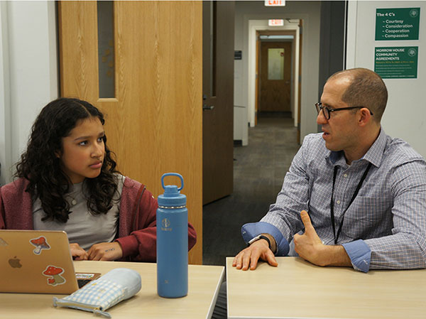 Jed Silverstein speaking with a student.