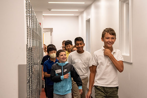 Fifth graders walking through Morrow House hallway.