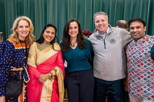 Head of School Marek Beck and Amelia Gold posing with parents at our Cultural Fair