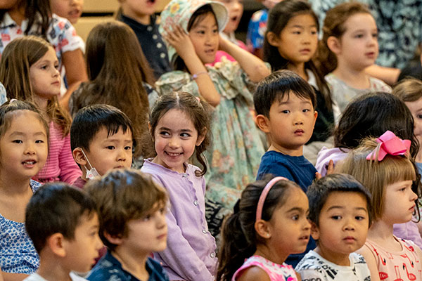 Little School students smiling in the audience during Kindergarten Circus