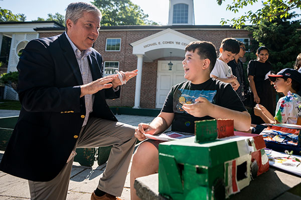 Head of School Marek Beck talking with a student about his food truck