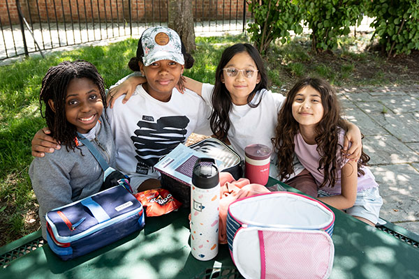 A group of girls smiling at lunch