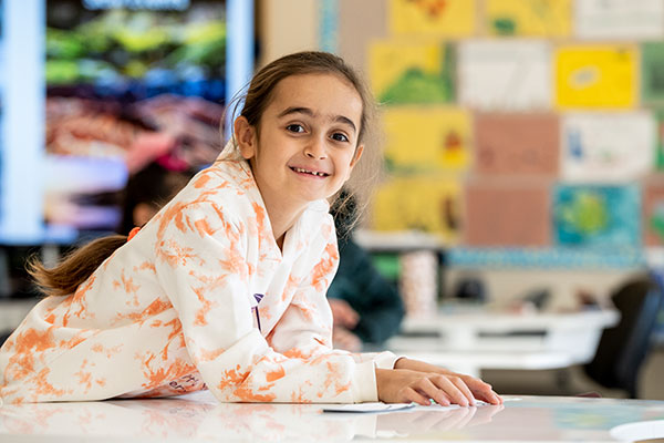 Little School student smiling at the camera