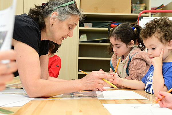 Teacher helps students during El Estudio class in Chilton House