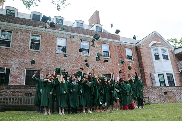 2023 graduates throwing up their caps