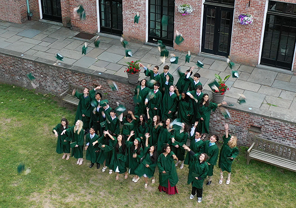 2023 graduates toss cap into the air
