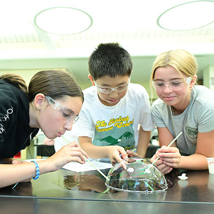 Three students working on a science project in Morrow House