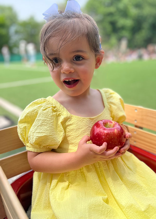 Young student holding apple 2024