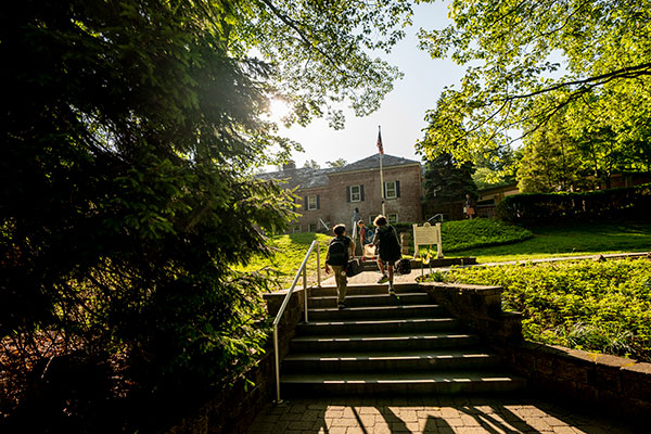 Exterior of Little School campus with students walking into the building