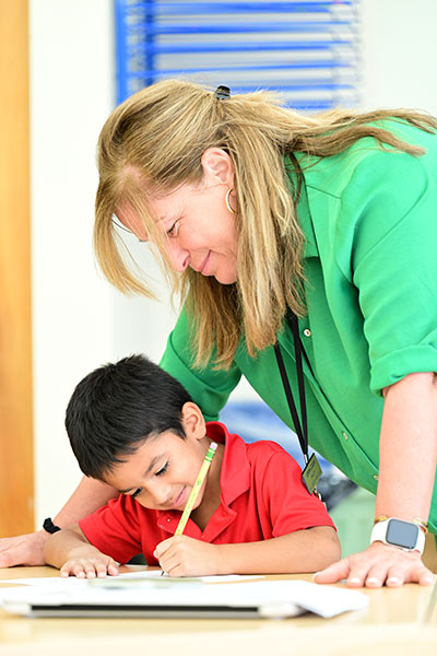 A Chilton House teacher helping a student.