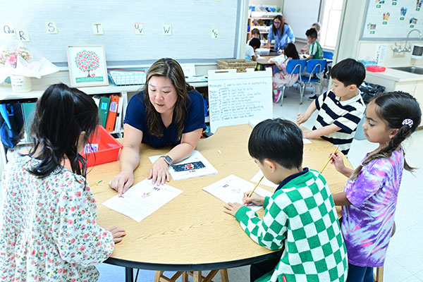 Little School students in first grade working with their teacher in a flexible learning group