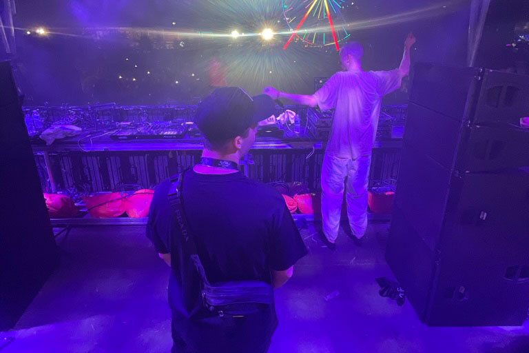 Thomas Insana '16 at a festival with an artist.