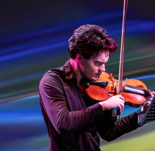 Dylan Hamme performing with his violin.